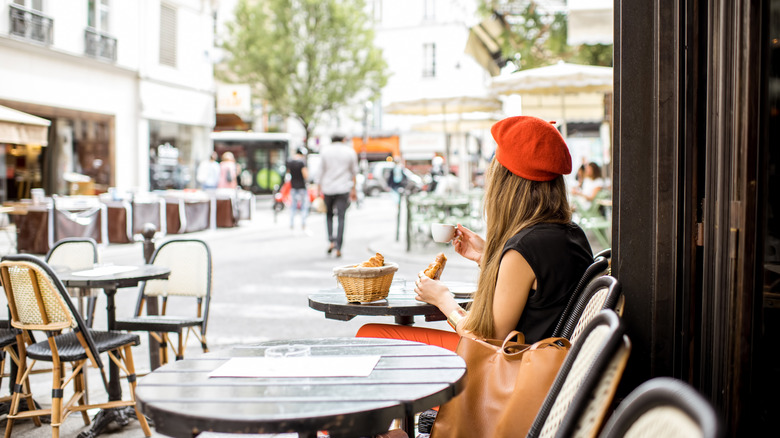 woman with croissants and coffee