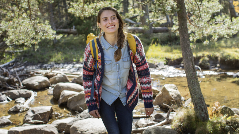 smiling woman hiking in forest