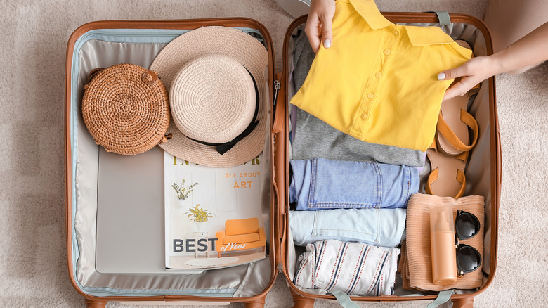 Person packing suitcase