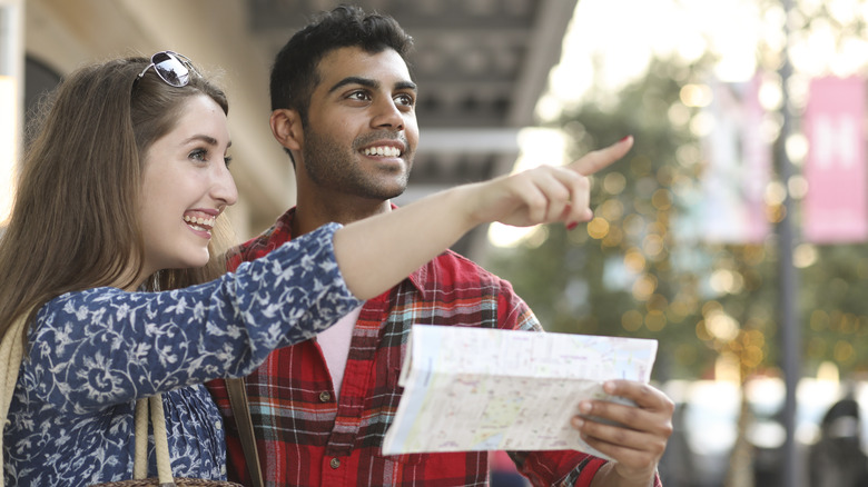 tourist couple using map