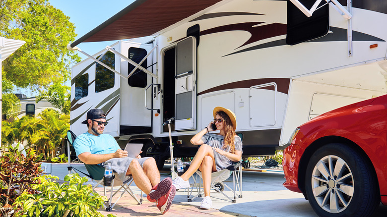 Couple sitting near their RV