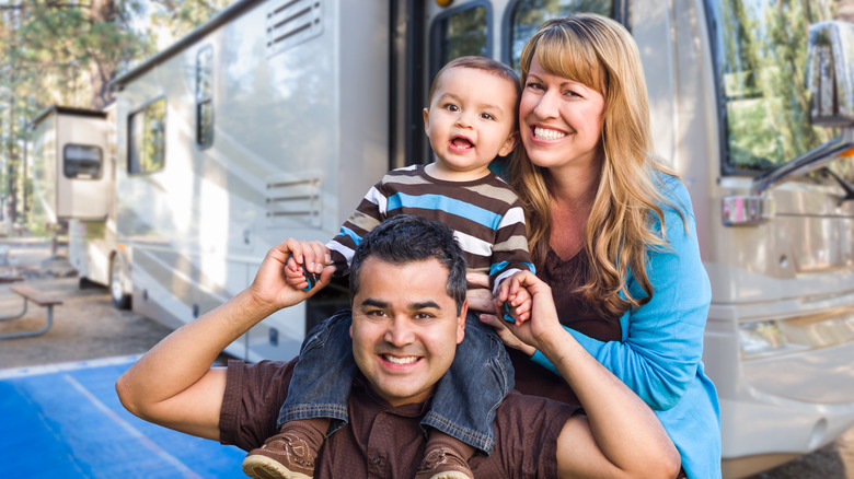 Laughing family with RV