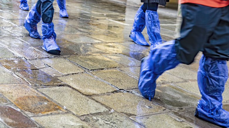 Tourists walking in shoe covers