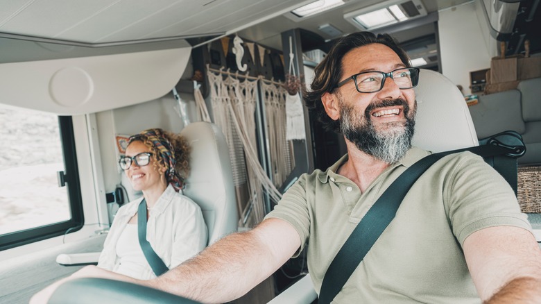 Happy couple driving RV