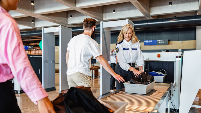 travelers going through airport security