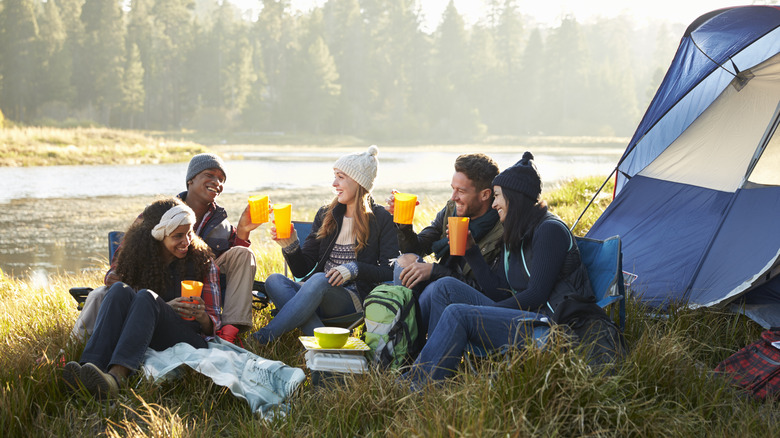 Group of people sitting outside tent