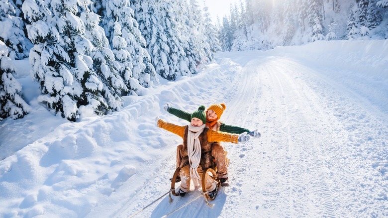 Kids sledding in the mountains