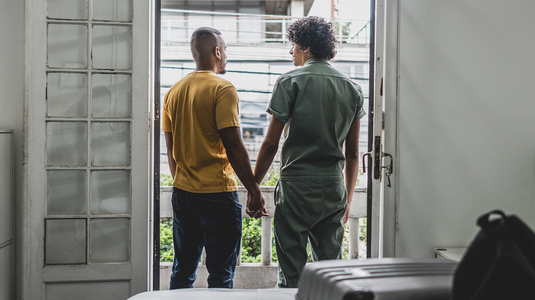 Couple holding hands in hotel