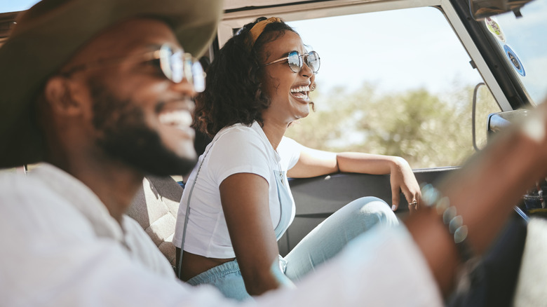 happy couple riding in car