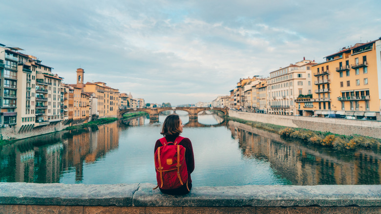 Woman sitting on Florence bridge