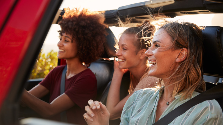 friends driving in a convertible