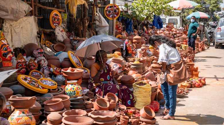 Woman looking at pottery