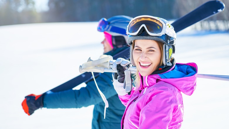 People carrying skis on a snowy mountain