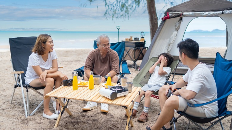 Family summer-camping by the water