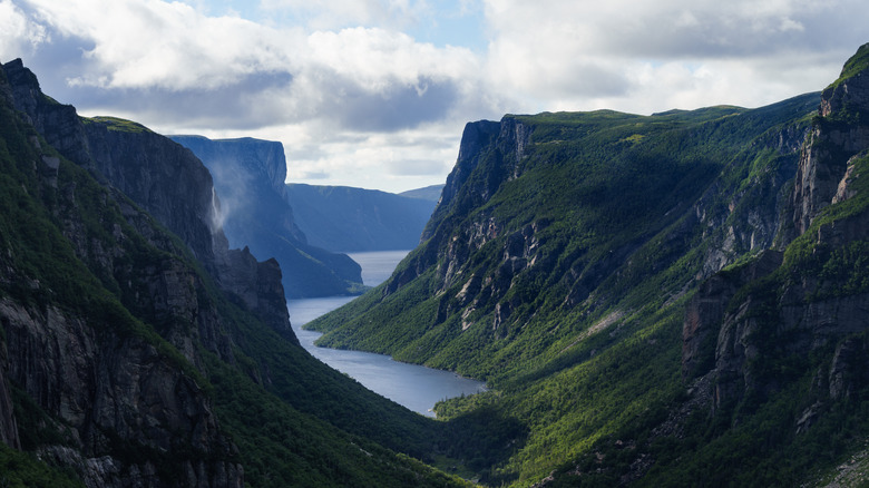 Canada's Dreamlike Fjord Lake: A Stunning National Park Marvel Featuring Towering Cliffs and Misty Waters