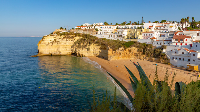 Portugal's Sunlit Village: A Vibrant Summer Haven of Limestone Cliffs and Golden Beaches