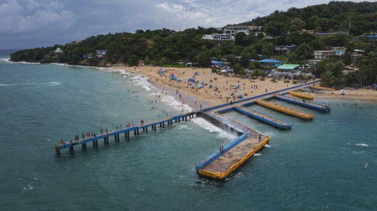 Puerto Rico's Tropical Beach: A Postcard-Perfect Scene with Rainbow Fish and a Sunken Pier